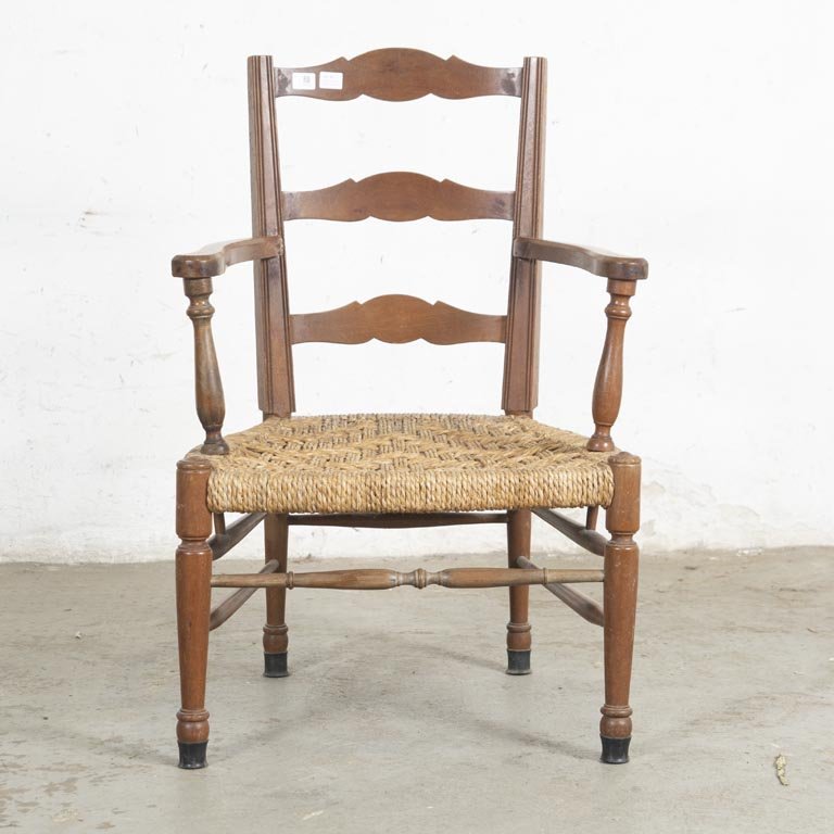 Sillón bajo de madera y fibras naturales con detalles