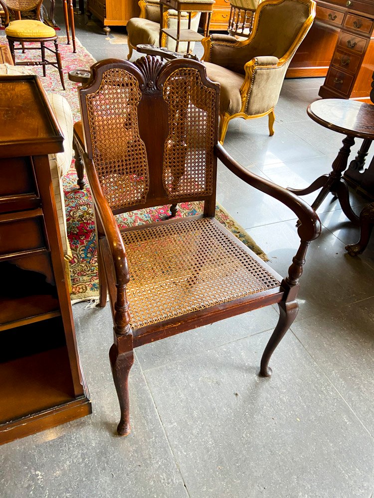 Sillón de madera con asiento y respaldo de mimbre