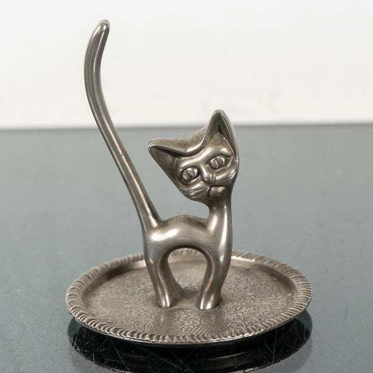 Despojador de Metal con Figura de Gato Estilizado