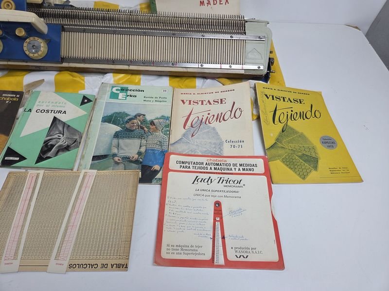 Máquina de tejer con forro de lona y cantidad de manuales y revistas de tejidos - imagen 7