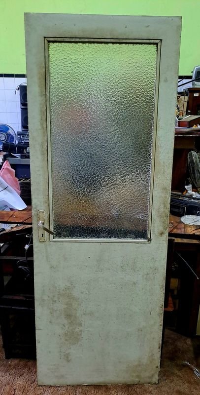 Puerta antigua con vidrio y detalles de madera