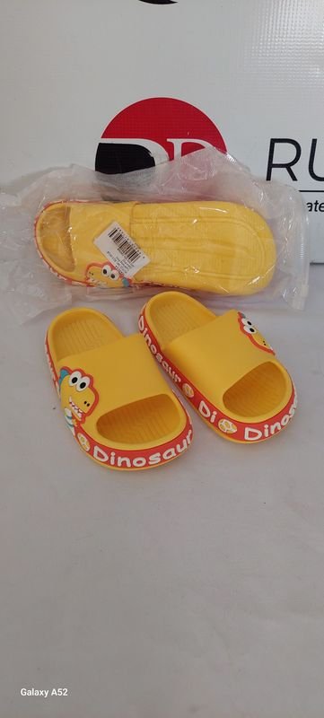 Lote siguiente: Zapatillas amarillas con diseño de dinosaurios