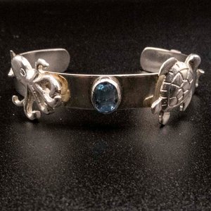 Lote siguiente: Pulsera Esclava de Plata 950 con Topacio y Dijes Marinos