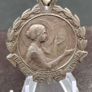 Lote siguiente: Medalla "Primer Premio" Solfeo "Santa Cecilia" Montevideo Abril 2-1914