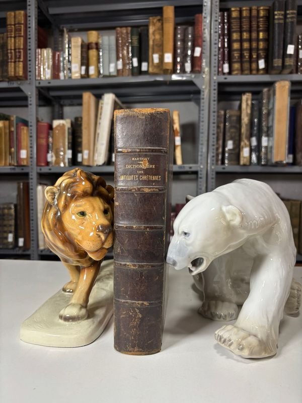 Lote siguiente: Diccionario de Antigüedades Cristianas de 1889 - Libro antiguo con estatuas de león y oso polar